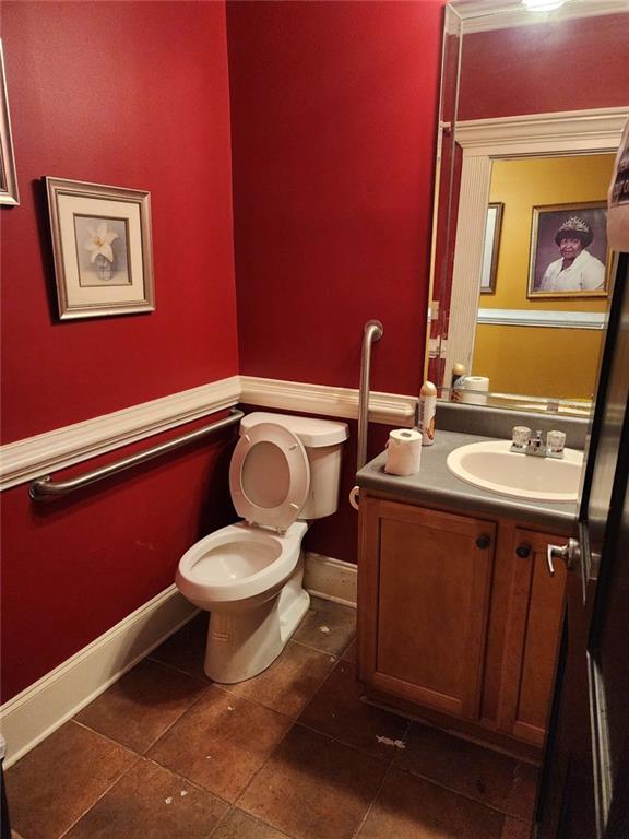 6958 Main Street Lithonia, GA 30058 - Photo 50 of 55 a bathroom with a toilet a sink and mirror