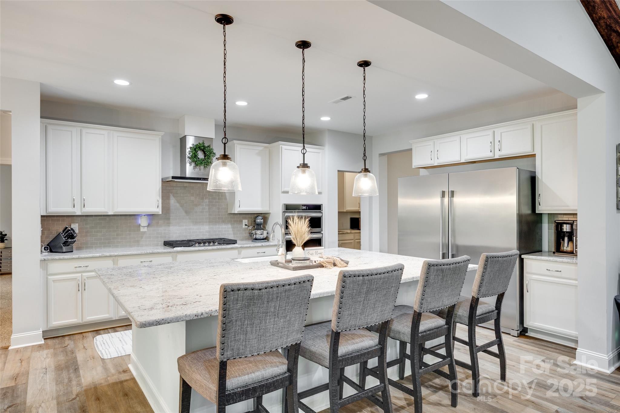 1336 West Rebound Road Lancaster, SC 29720 - Photo 1 of 45 a kitchen with stainless steel appliances kitchen island granite countertop a dining table chairs refrigerator and sink