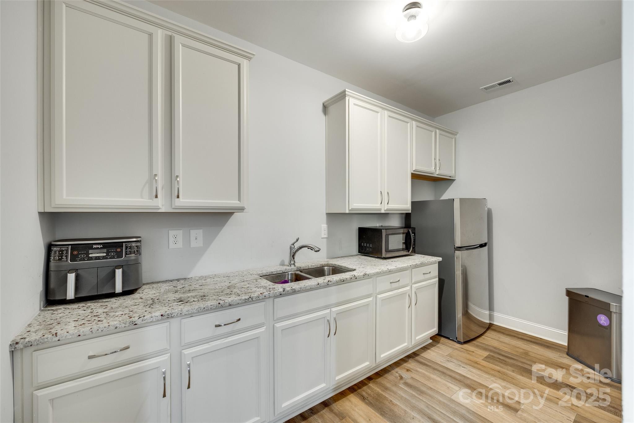 1336 West Rebound Road Lancaster, SC 29720 - Photo 12 of 45 a kitchen with granite countertop white cabinets and white appliances