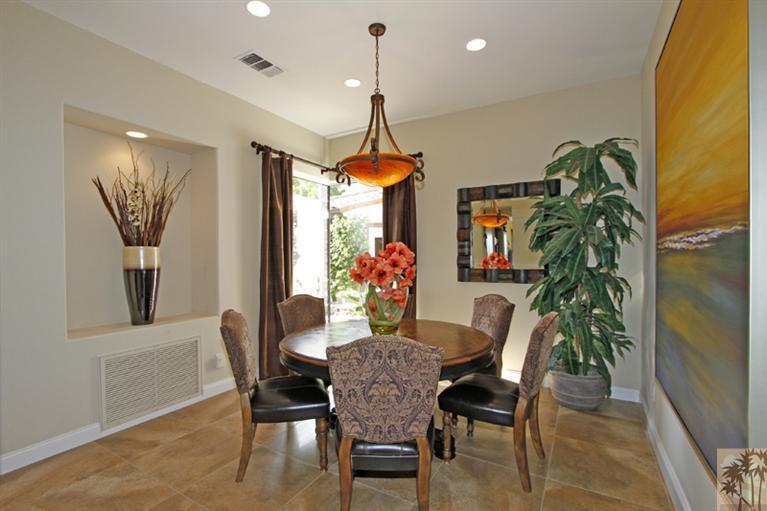 124 Loch Lomond Road Rancho Mirage, CA 92270 - Photo 12 of 25 a dining room with furniture potted plants and wooden floor