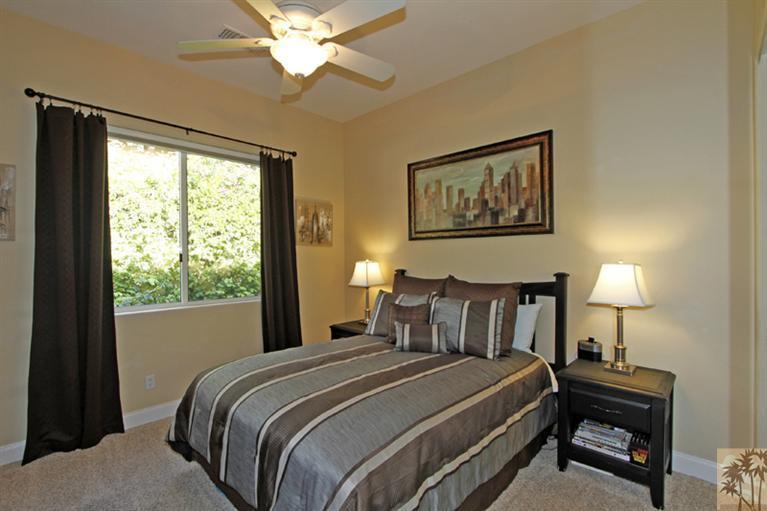 124 Loch Lomond Road Rancho Mirage, CA 92270 - Photo 19 of 25 a bedroom with a bed and a lamp