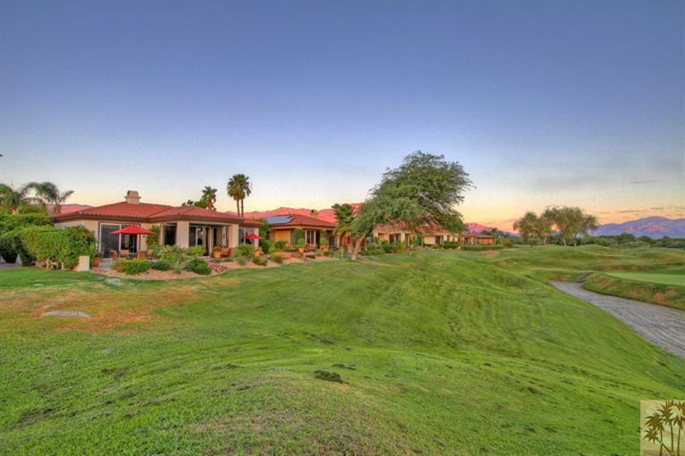 124 Loch Lomond Road Rancho Mirage, CA 92270 - Photo 3 of 25 a view of a big house with a big yard and potted plants
