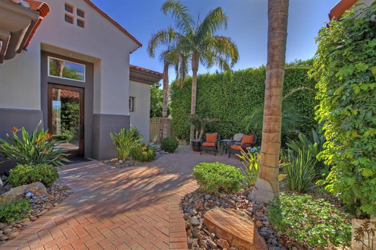 124 Loch Lomond Road Rancho Mirage, CA 92270 - Photo 5 of 25 a view of a backyard with potted plants and a palm tree