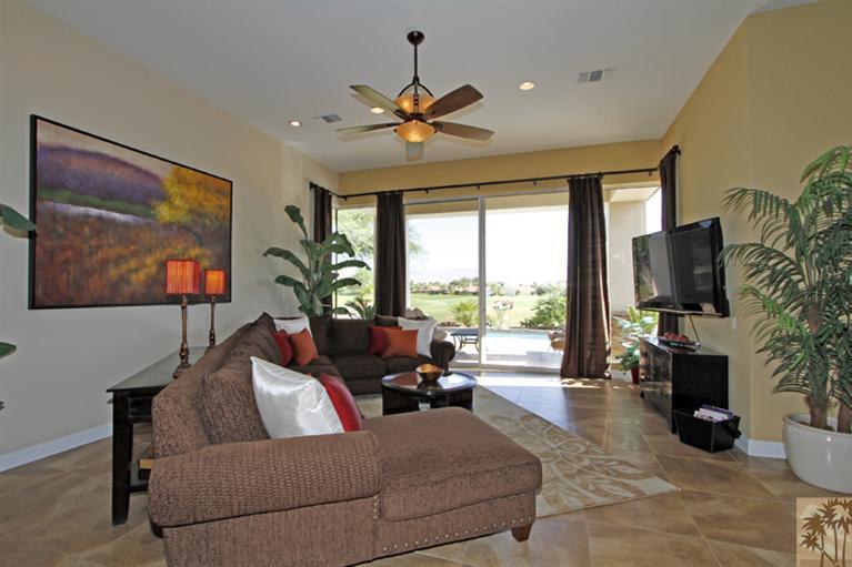 124 Loch Lomond Road Rancho Mirage, CA 92270 - Photo 9 of 25 a living room with furniture a large window and a flat screen tv