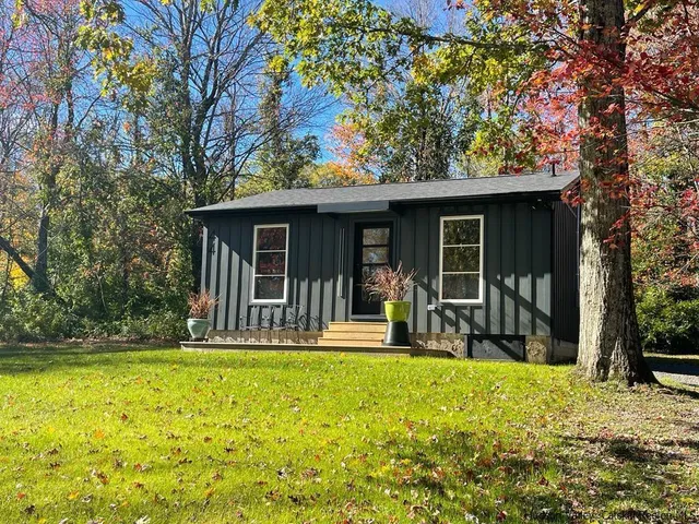 a front view of a house with garden and porch