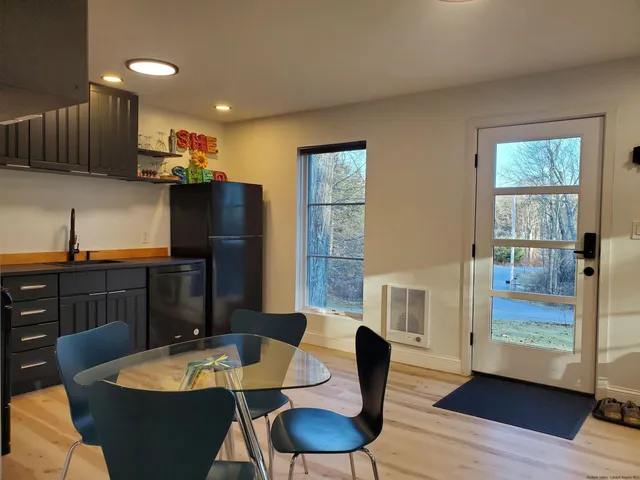 a dining room with furniture and wooden floor