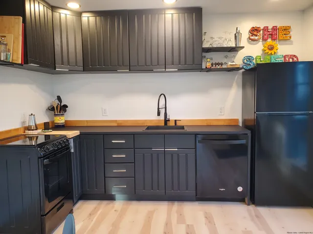 a kitchen with a sink and cabinets