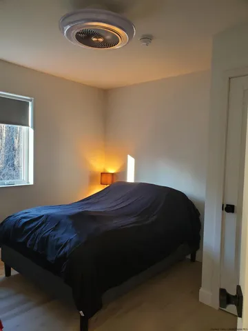 a bedroom with a bed and a lamp