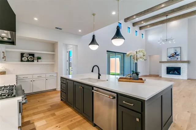a kitchen with a sink appliances and cabinets