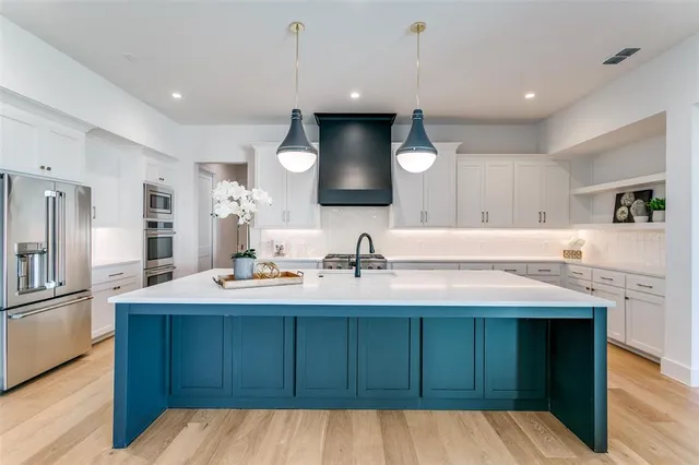 a kitchen with a sink and a refrigerator
