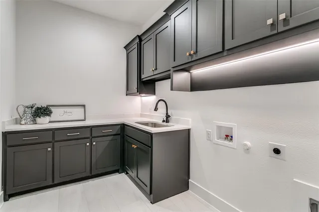 a kitchen with a sink cabinets and stainless steel appliances