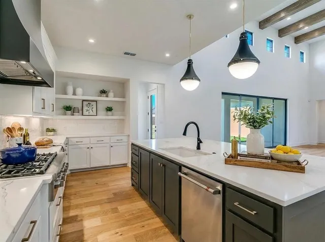 a kitchen with a sink cabinets and wooden floor