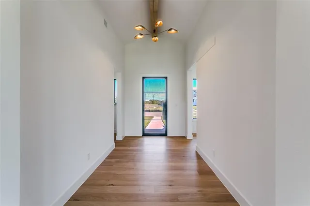 a view of a hallway with wooden floor