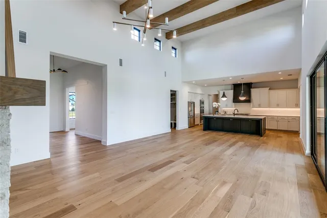 a view of a kitchen with a sink and a large window