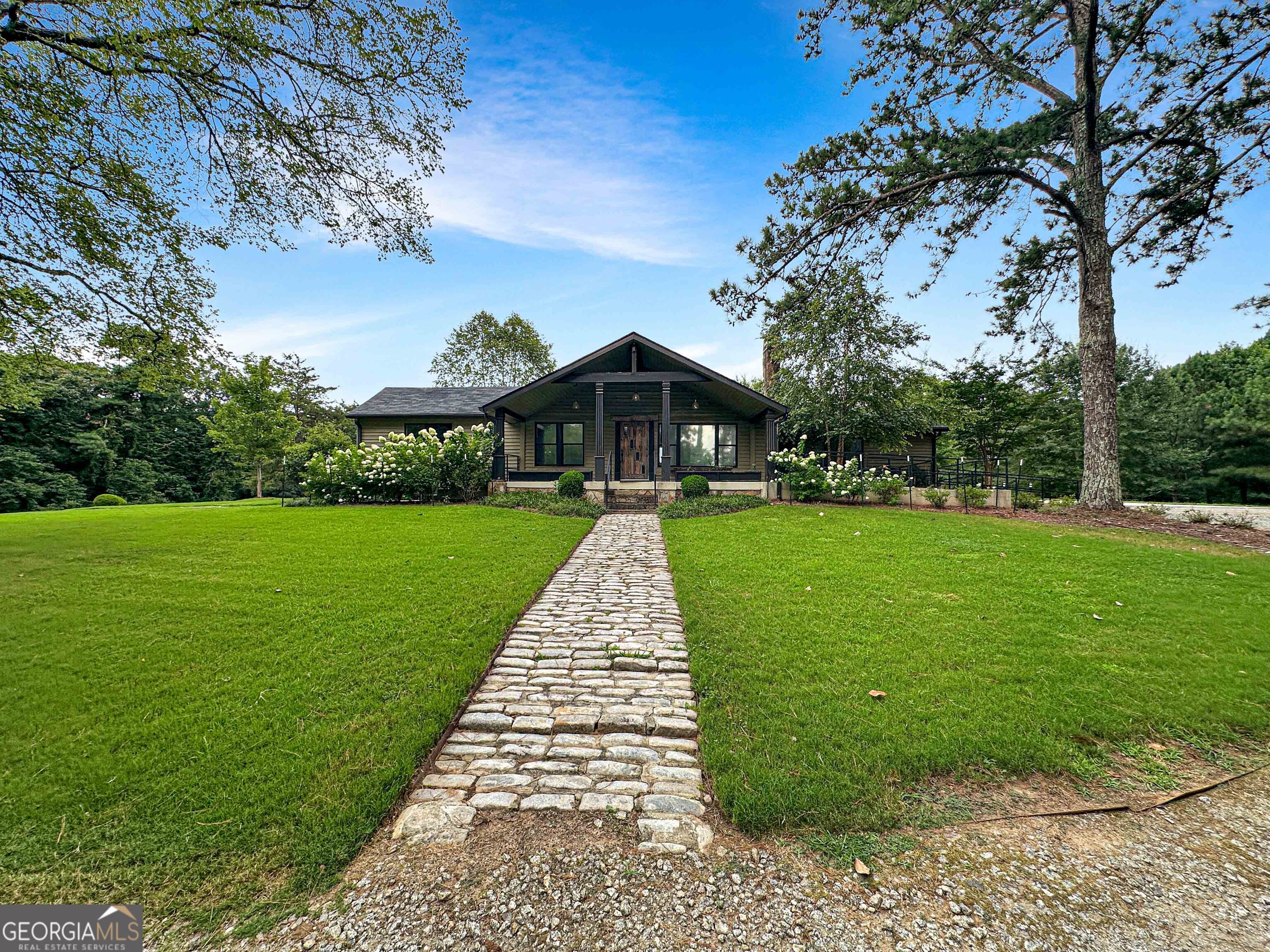 a front view of a house with garden
