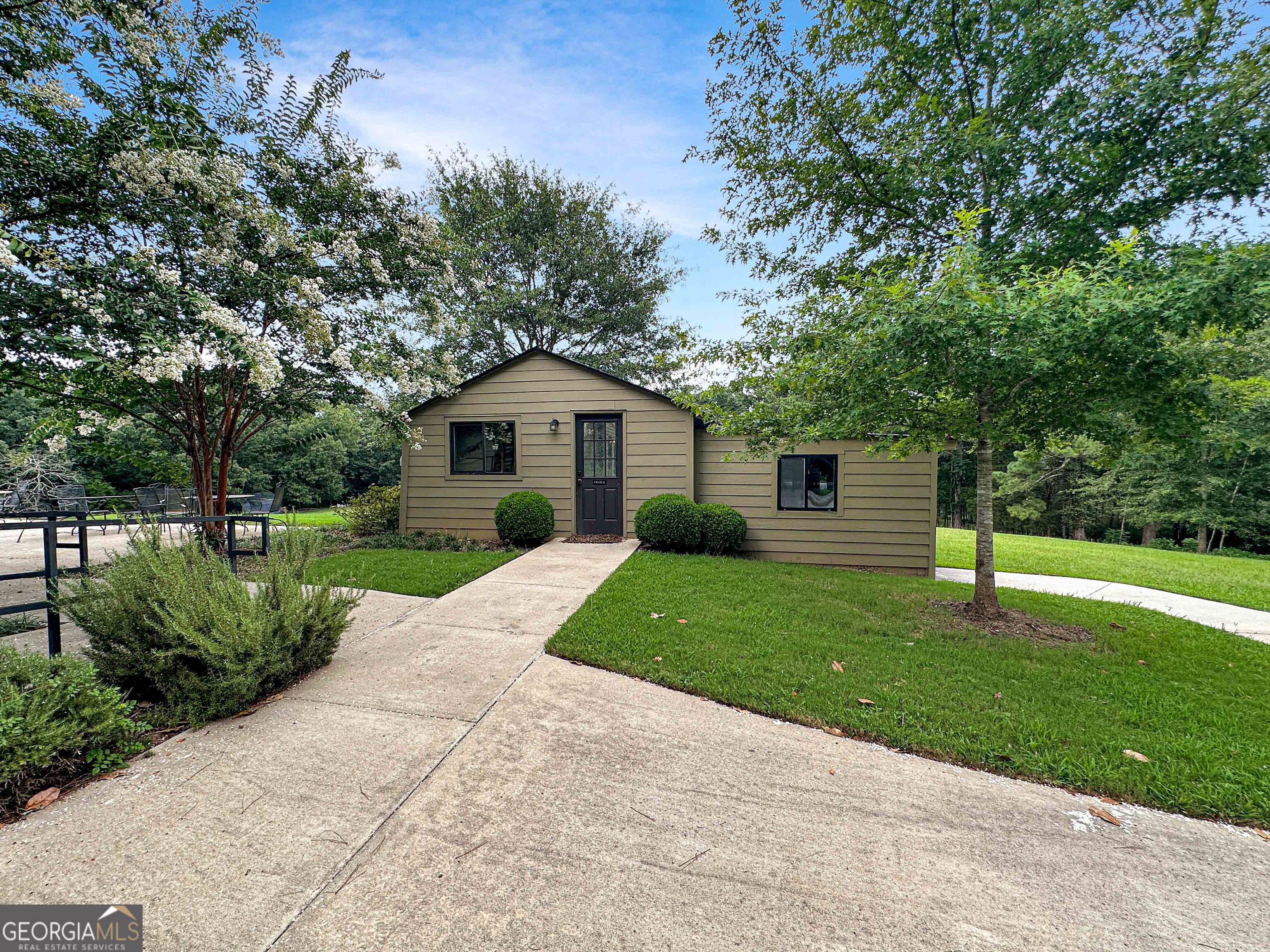 8400 Atlanta Newnan Road Chattahoochee Hills, GA 30268 - Photo 11 of 30 a front view of a house with a yard