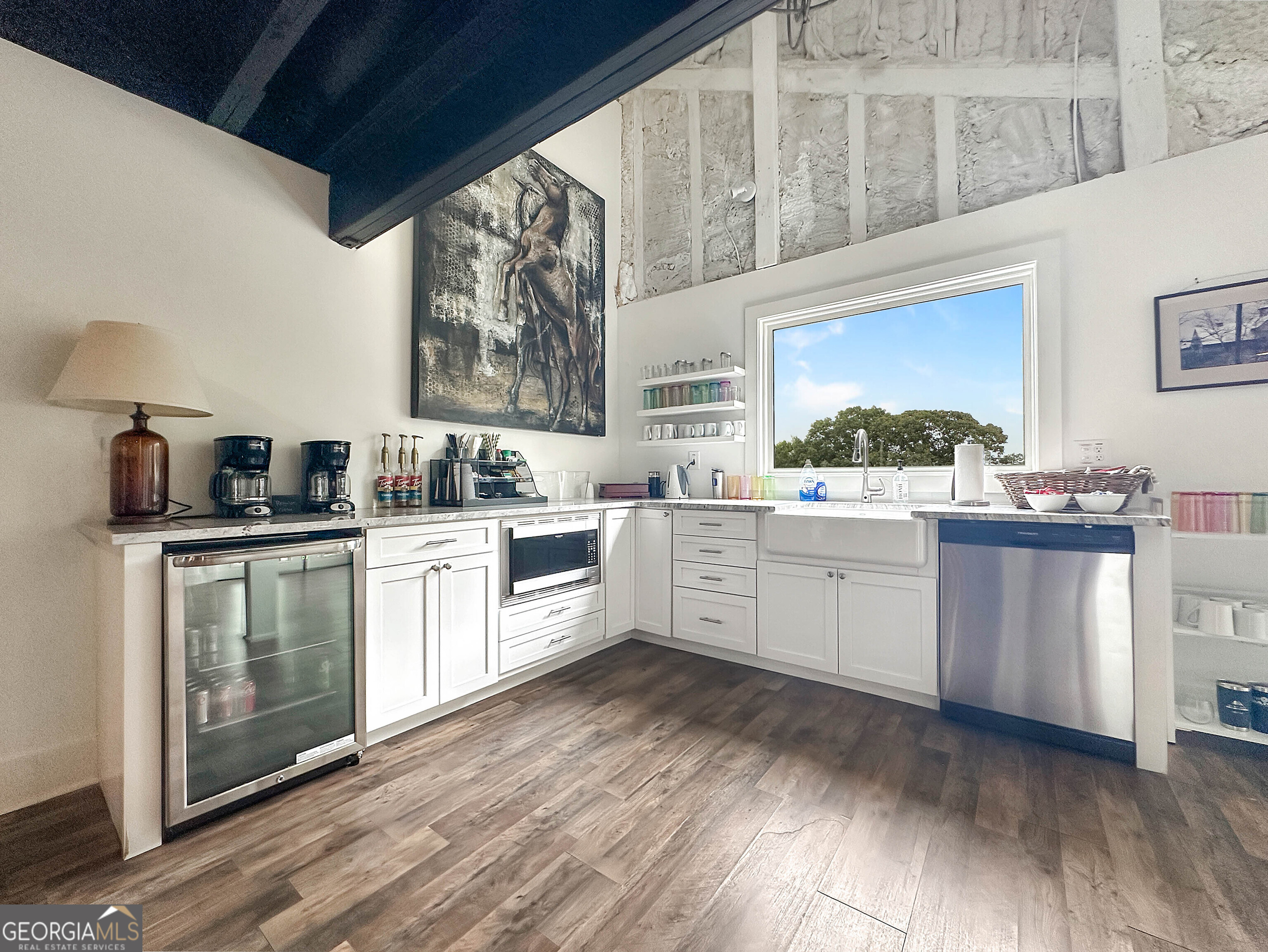 8400 Atlanta Newnan Road Chattahoochee Hills, GA 30268 - Photo 16 of 30 a kitchen with a sink cabinets and wooden floor