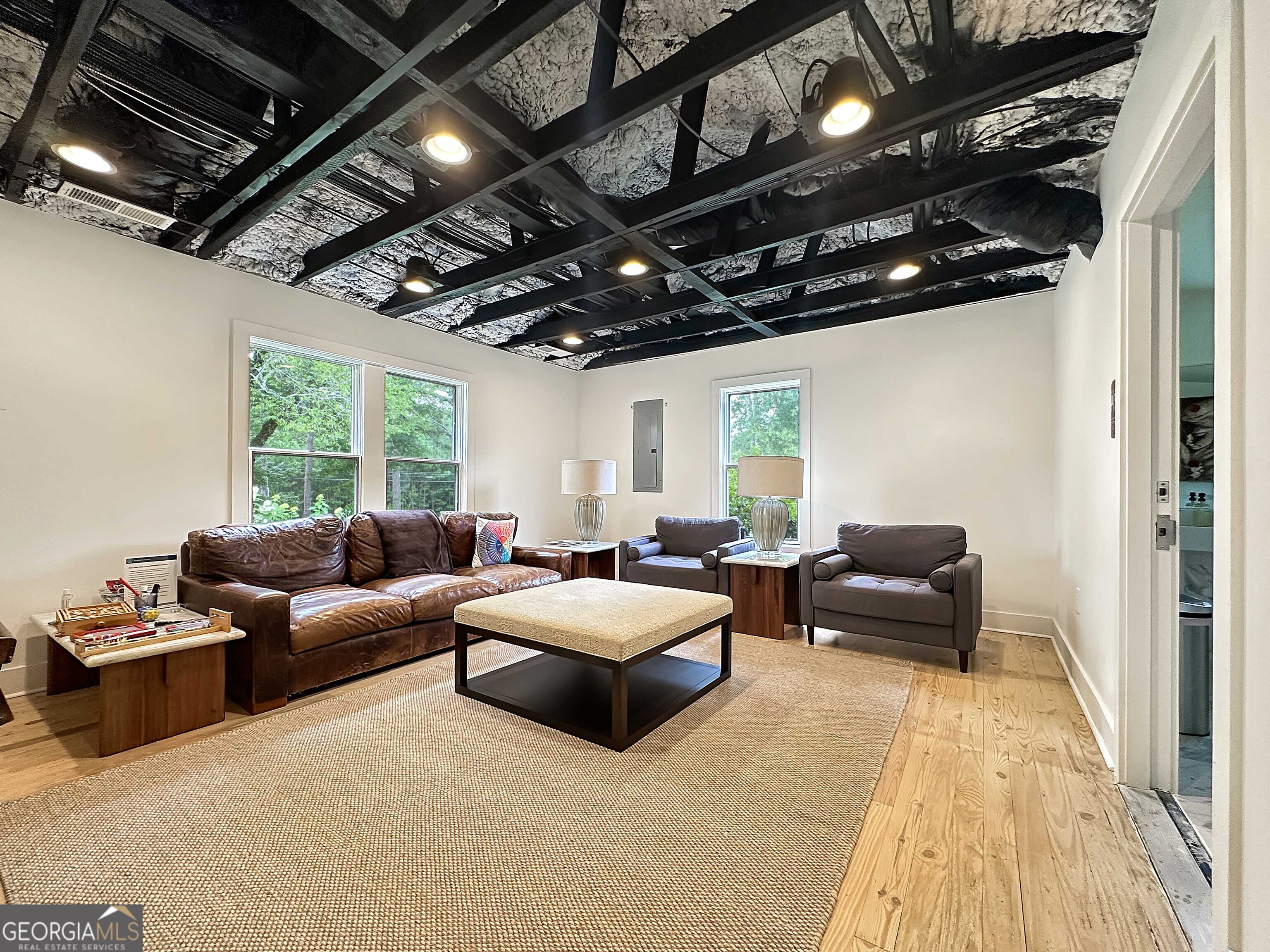 8400 Atlanta Newnan Road Chattahoochee Hills, GA 30268 - Photo 18 of 30 a living room with furniture and a chandelier