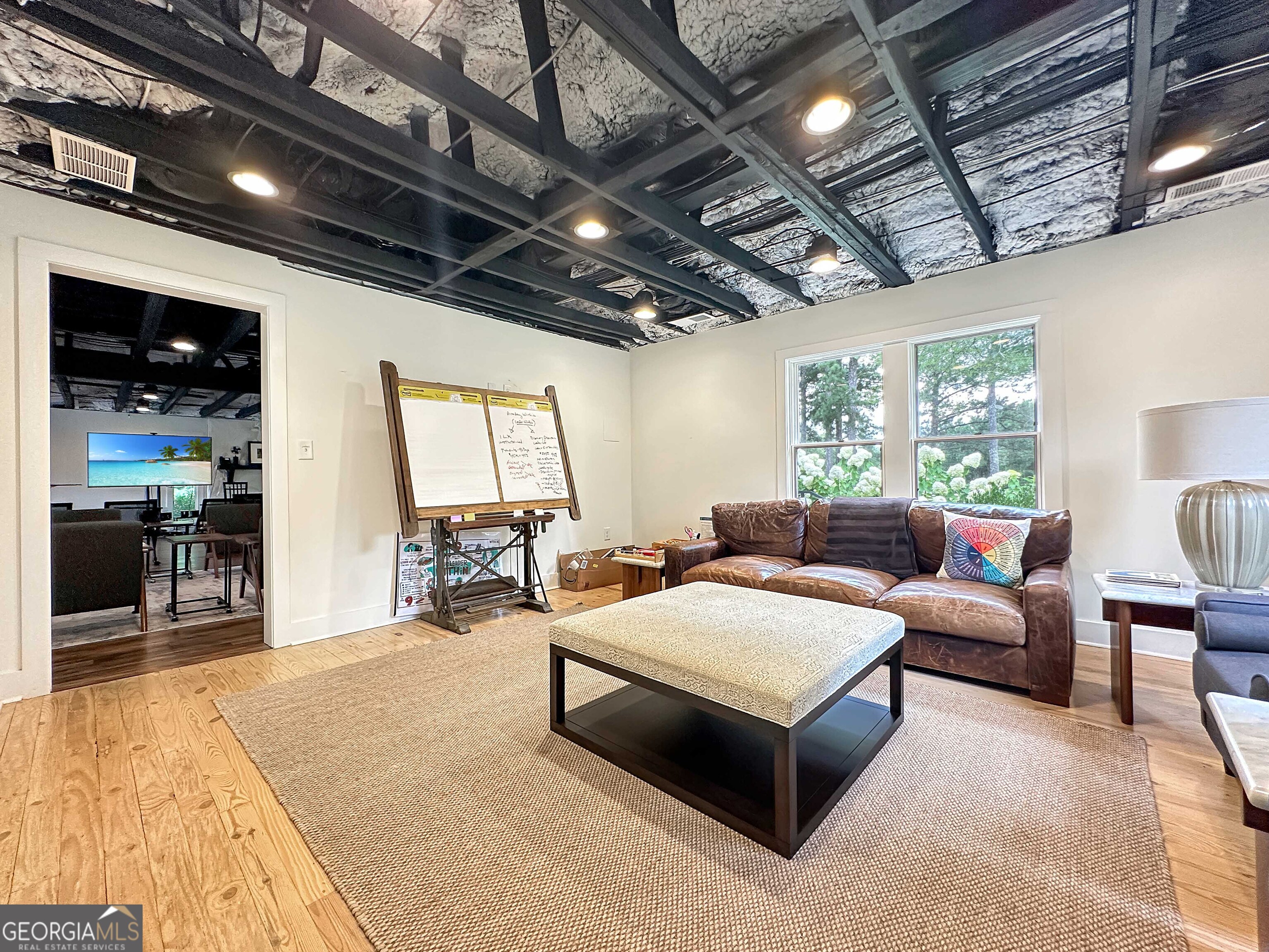 8400 Atlanta Newnan Road Chattahoochee Hills, GA 30268 - Photo 20 of 30 a living room with furniture and a flat screen tv
