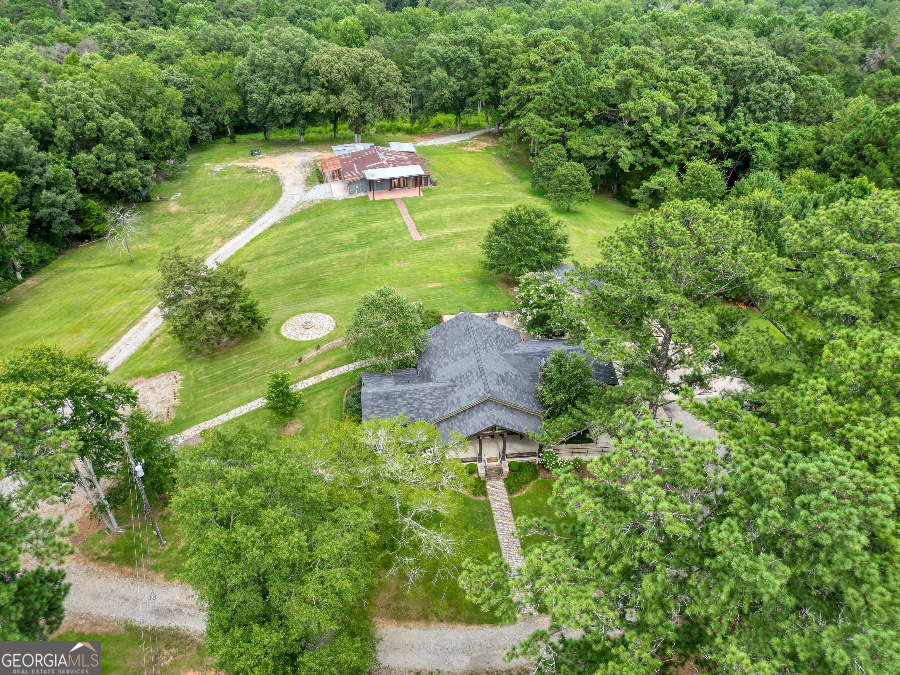 8400 Atlanta Newnan Road Chattahoochee Hills, GA 30268 - Photo 2 of 30 an aerial view of residential house with outdoor space and trees all around