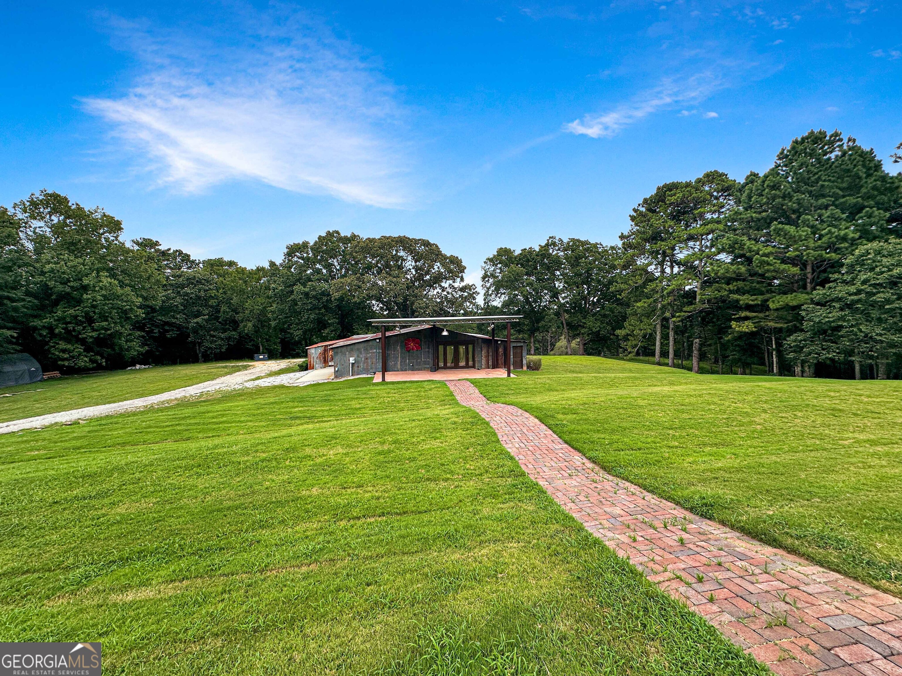 8400 Atlanta Newnan Road Chattahoochee Hills, GA 30268 - Photo 26 of 30 a view of a grassy field with an trees