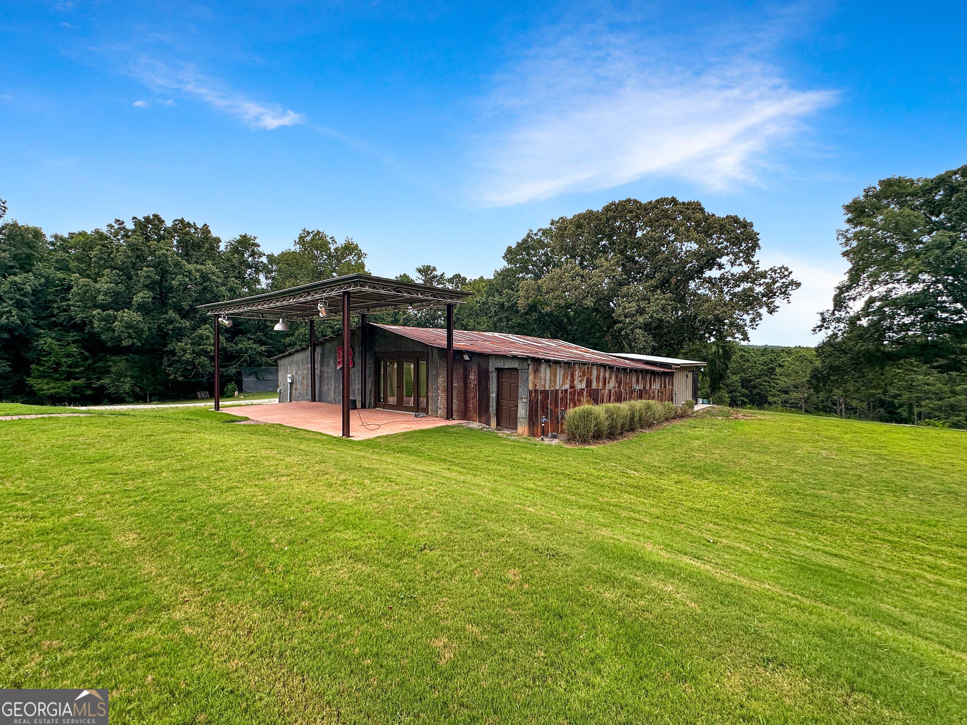8400 Atlanta Newnan Road Chattahoochee Hills, GA 30268 - Photo 27 of 30 a view of a house with backyard and garden
