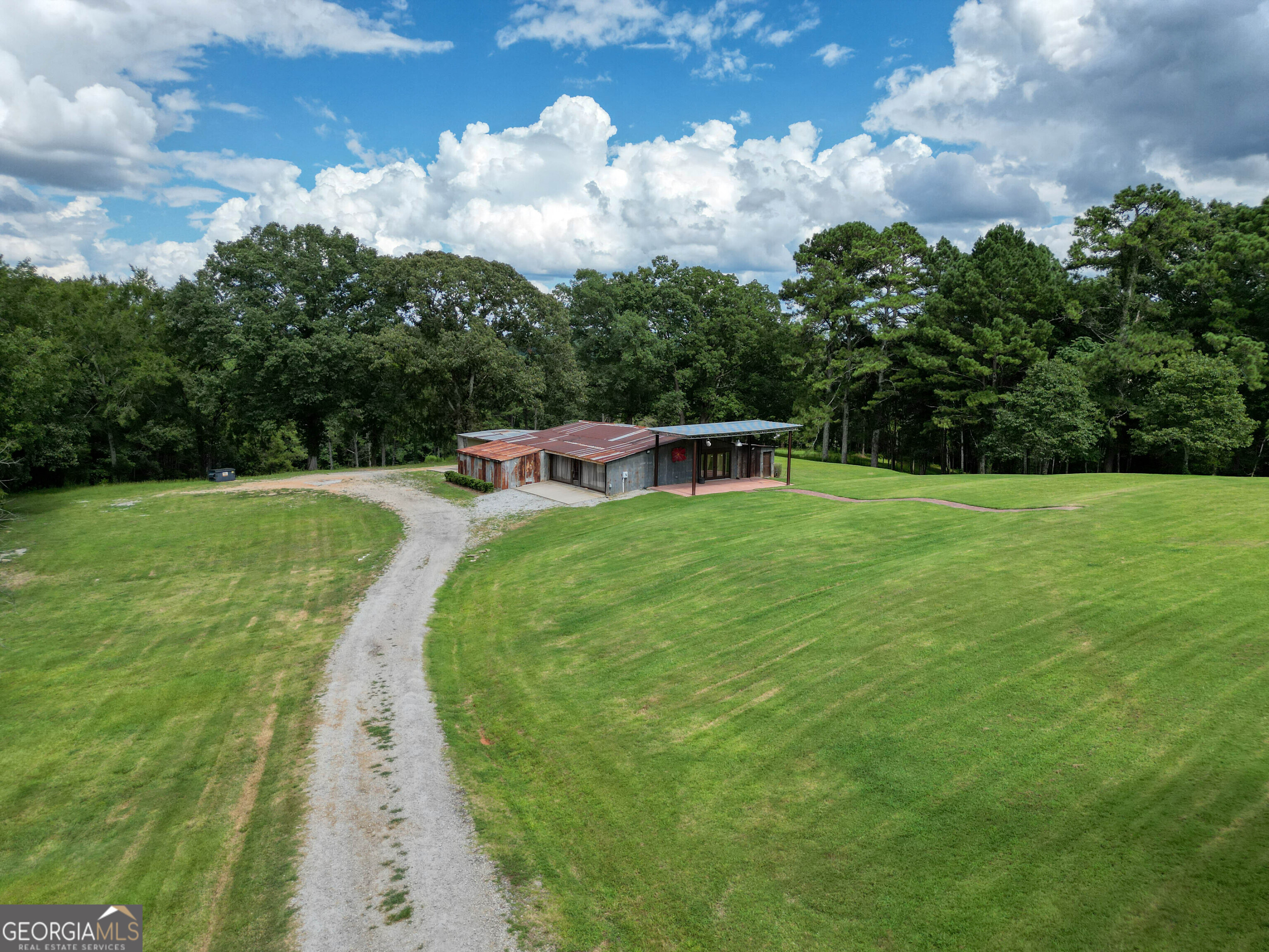 8400 Atlanta Newnan Road Chattahoochee Hills, GA 30268 - Photo 6 of 30 a view of a swimming pool with a yard