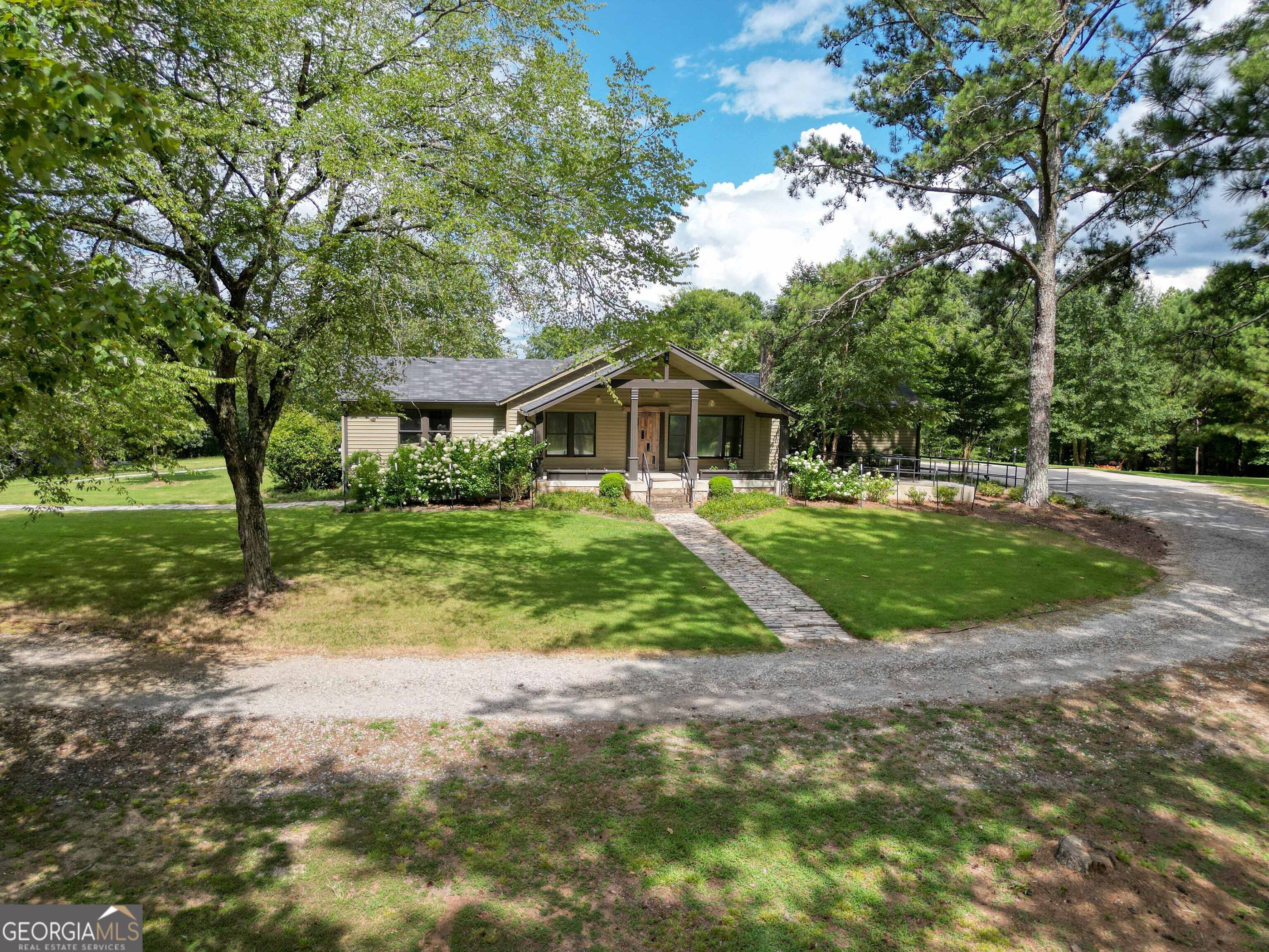 8400 Atlanta Newnan Road Chattahoochee Hills, GA 30268 - Photo 7 of 30 a front view of a house with a yard