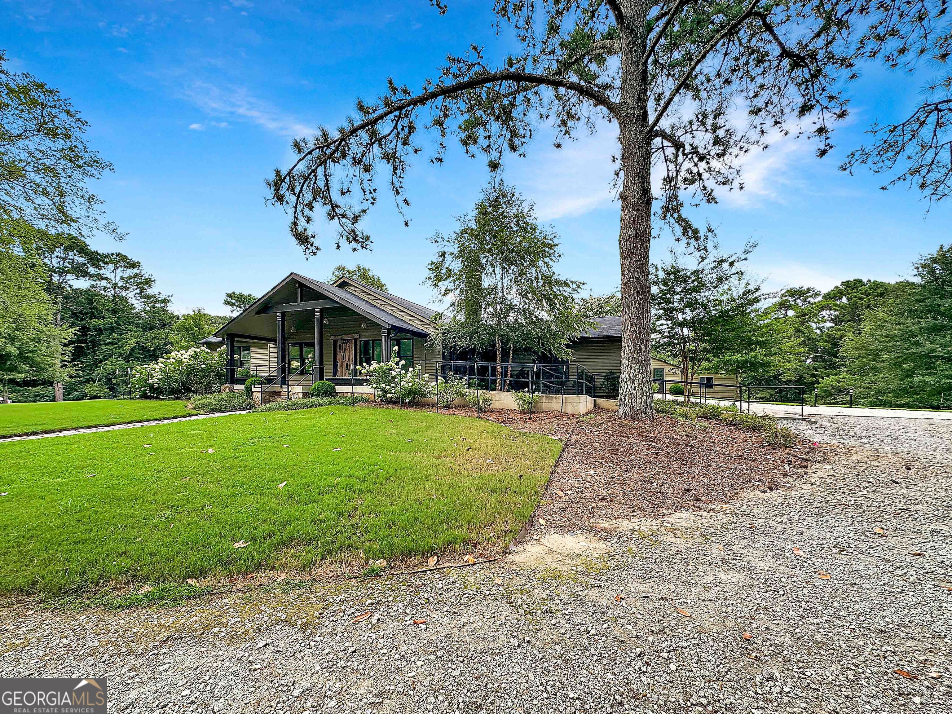 8400 Atlanta Newnan Road Chattahoochee Hills, GA 30268 - Photo 9 of 30 a front view of a house with garden