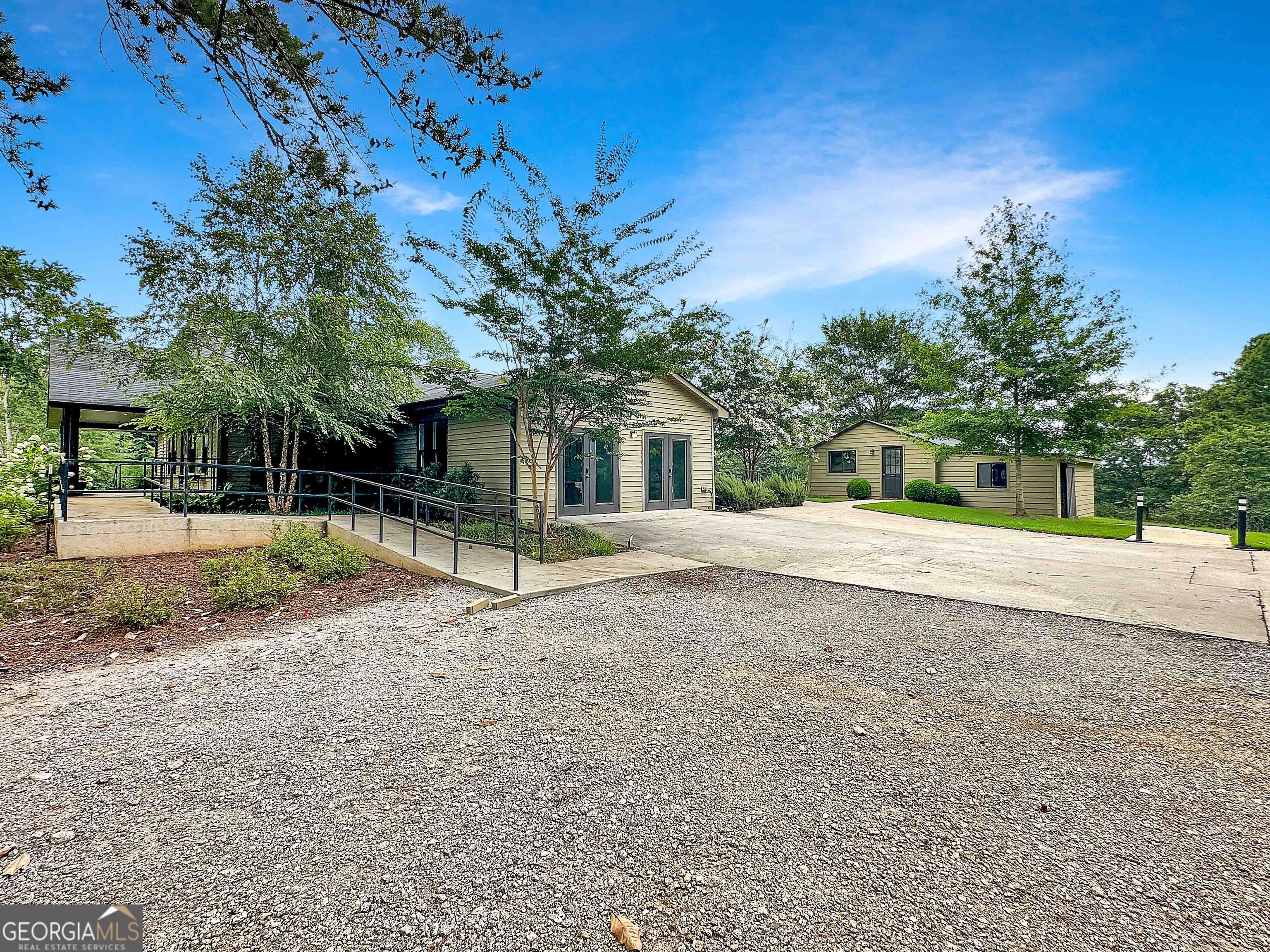 8400 Atlanta Newnan Road Chattahoochee Hills, GA 30268 - Photo 10 of 30 a house with trees in front of it