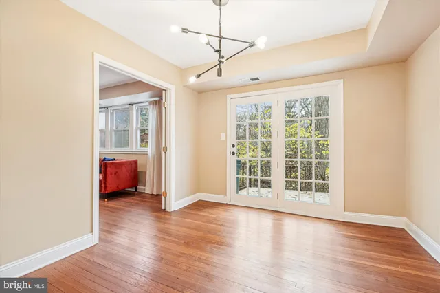 a view of a livingroom with wooden floor and a ceiling fan