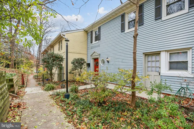 a yellow house with trees in front of it
