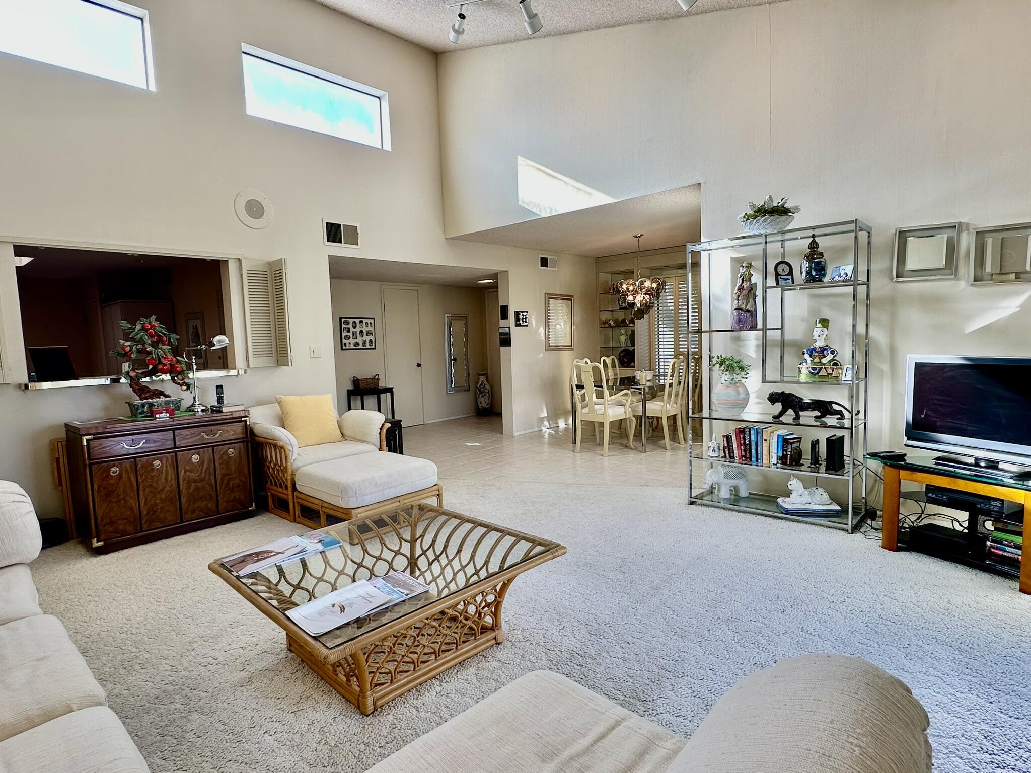 81 Marbella Drive Rancho Mirage, CA 92270 - Photo 8 of 17 a living room with furniture a rug and a flat screen tv