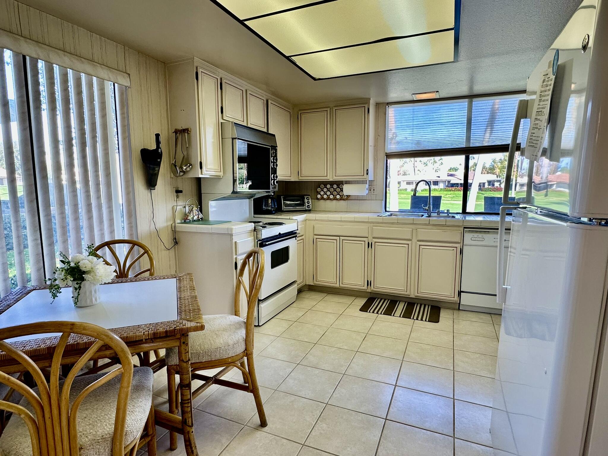 81 Marbella Drive Rancho Mirage, CA 92270 - Photo 9 of 17 a kitchen with stainless steel appliances granite countertop a stove a sink dishwasher and a refrigerator