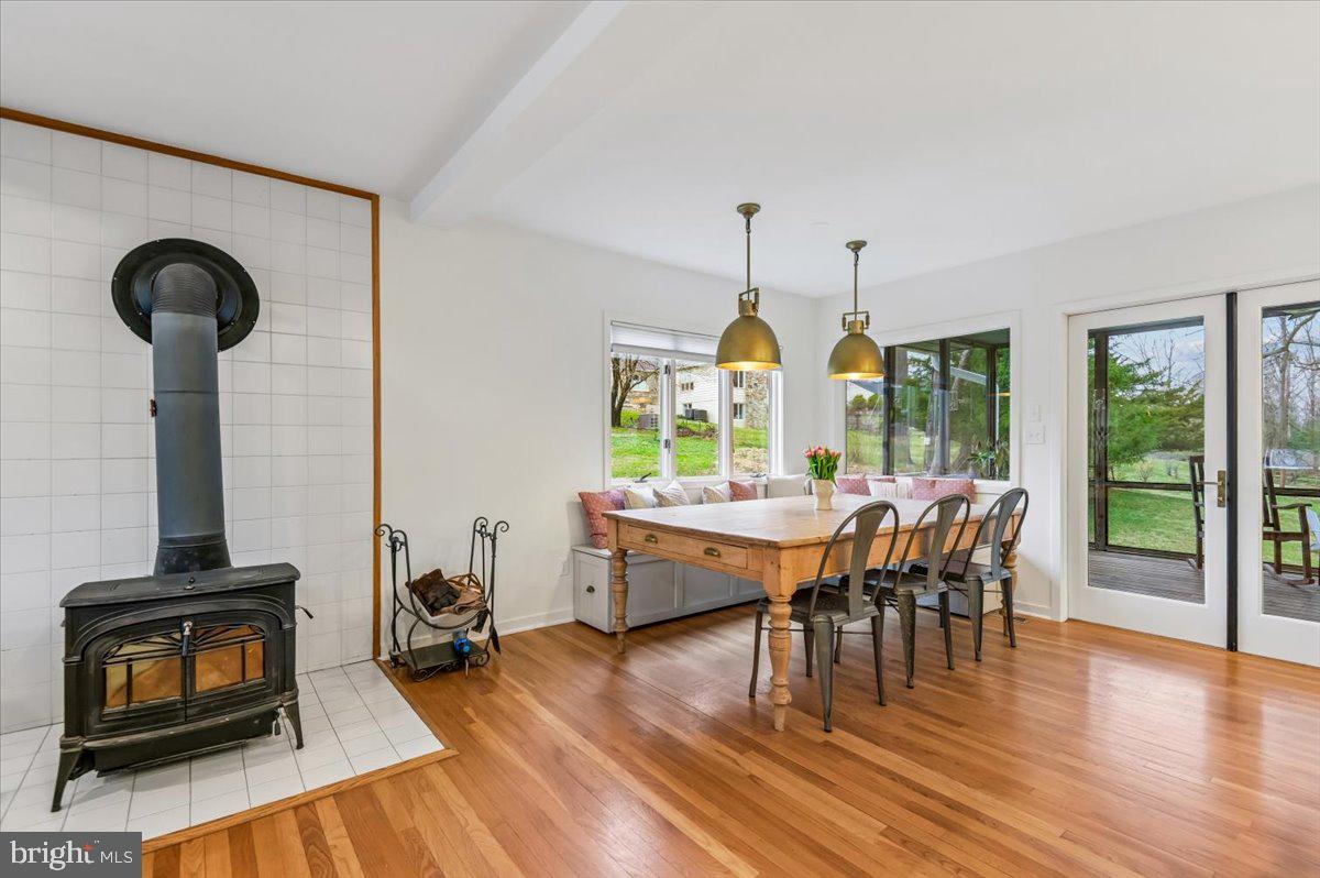 308 West Wind Road Towson, MD 21204 - Photo 12 of 80 a dining room with wooden floor furniture and a floor to ceiling window
