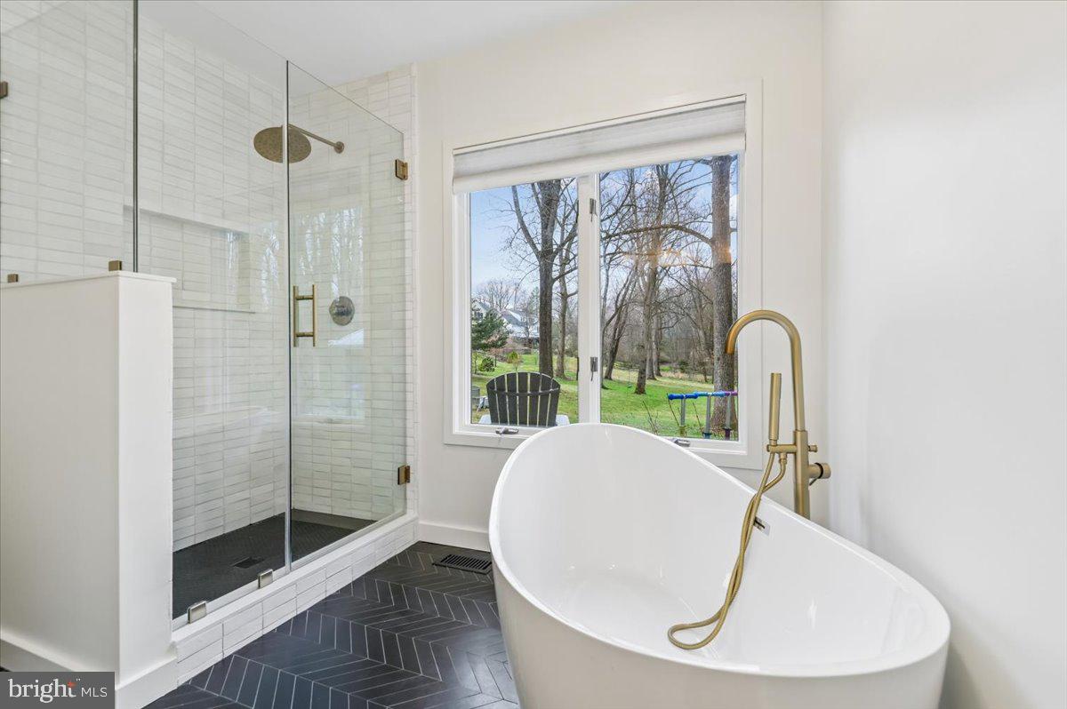 308 West Wind Road Towson, MD 21204 - Photo 32 of 80 a bathroom with a sink and a glass door shower
