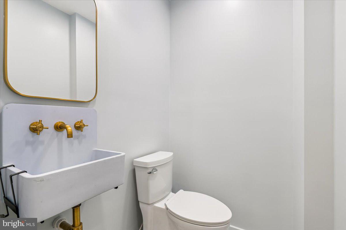 308 West Wind Road Towson, MD 21204 - Photo 33 of 80 a white toilet sitting next to a bathroom sink