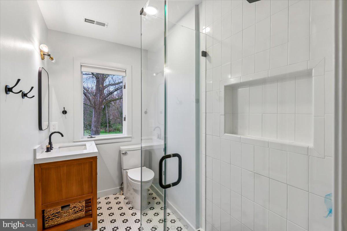 308 West Wind Road Towson, MD 21204 - Photo 40 of 80 a bathroom with a granite countertop sink a toilet and shower