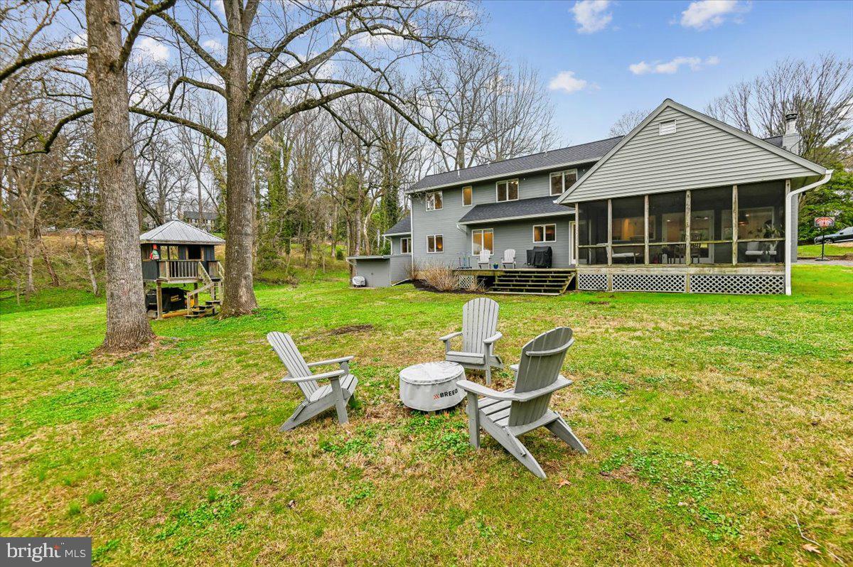 308 West Wind Road Towson, MD 21204 - Photo 64 of 80 a view of a house with a yard patio and fire pit