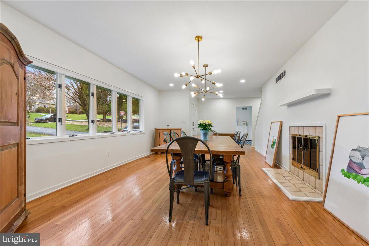 308 West Wind Road Towson, MD 21204 - Photo 5 of 80 a dining room with furniture a chandelier and wooden floor