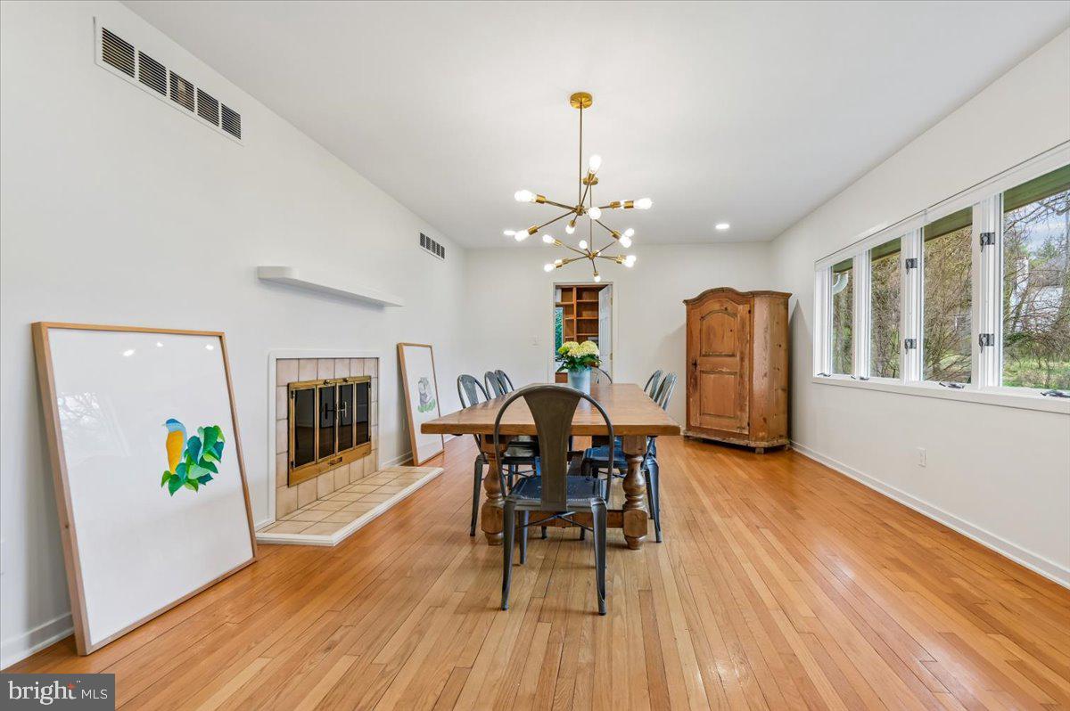 308 West Wind Road Towson, MD 21204 - Photo 6 of 80 a view of a dining room with furniture a chandelier and wooden floor