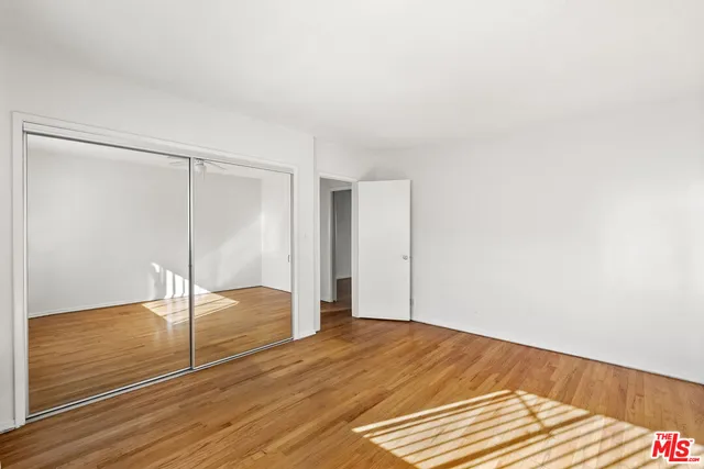 a view of a room with wooden floor
