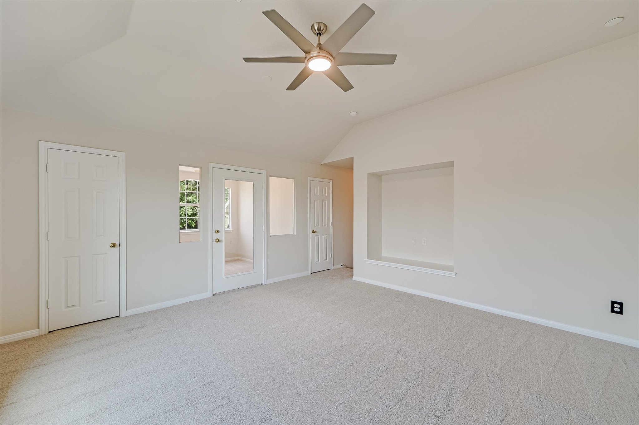 2849 Grimes Ranch Road Austin, TX 78732 - Photo 16 of 31 A well-lit bedroom features vaulted ceilings and soft carpeting, offering comfort and style.