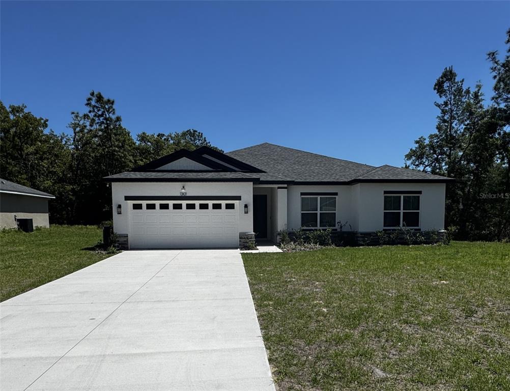 13101 Southwest 72nd Terrace Road Ocala, FL 34473 - Photo 1 of 18 front view of a house with a yard