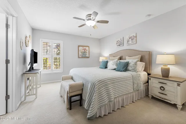 a bedroom with furniture and a flat screen tv