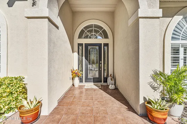 a front view of a house with a potted plant
