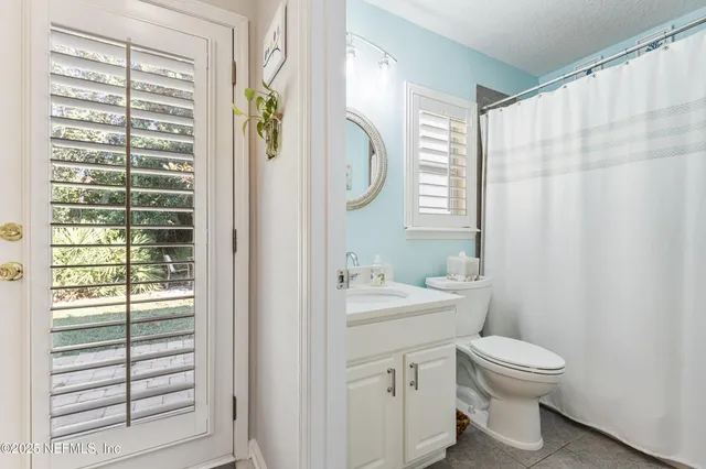 a bathroom with a toilet a sink and a mirror