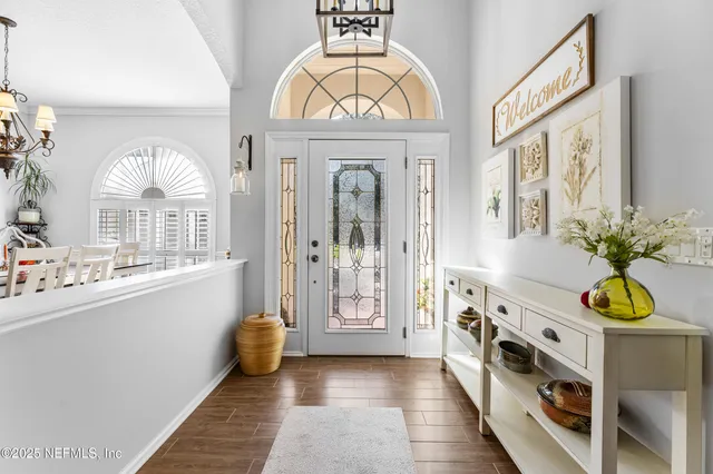 a view of a hallway with entryway front door