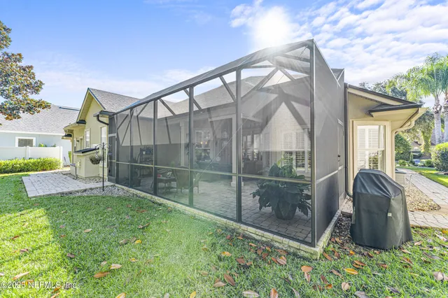 a backyard of a house with table and chairs