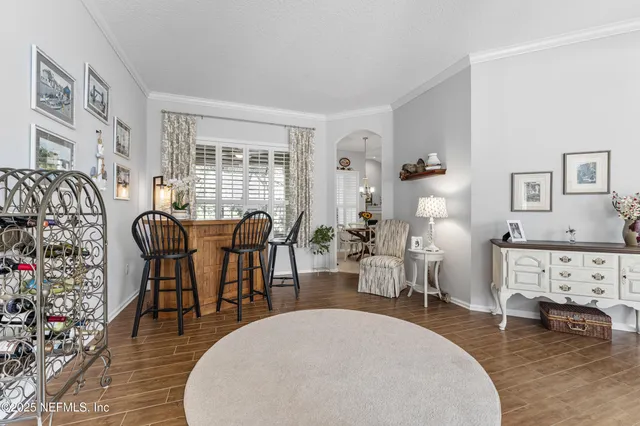 a living room with furniture a dining table and a fireplace